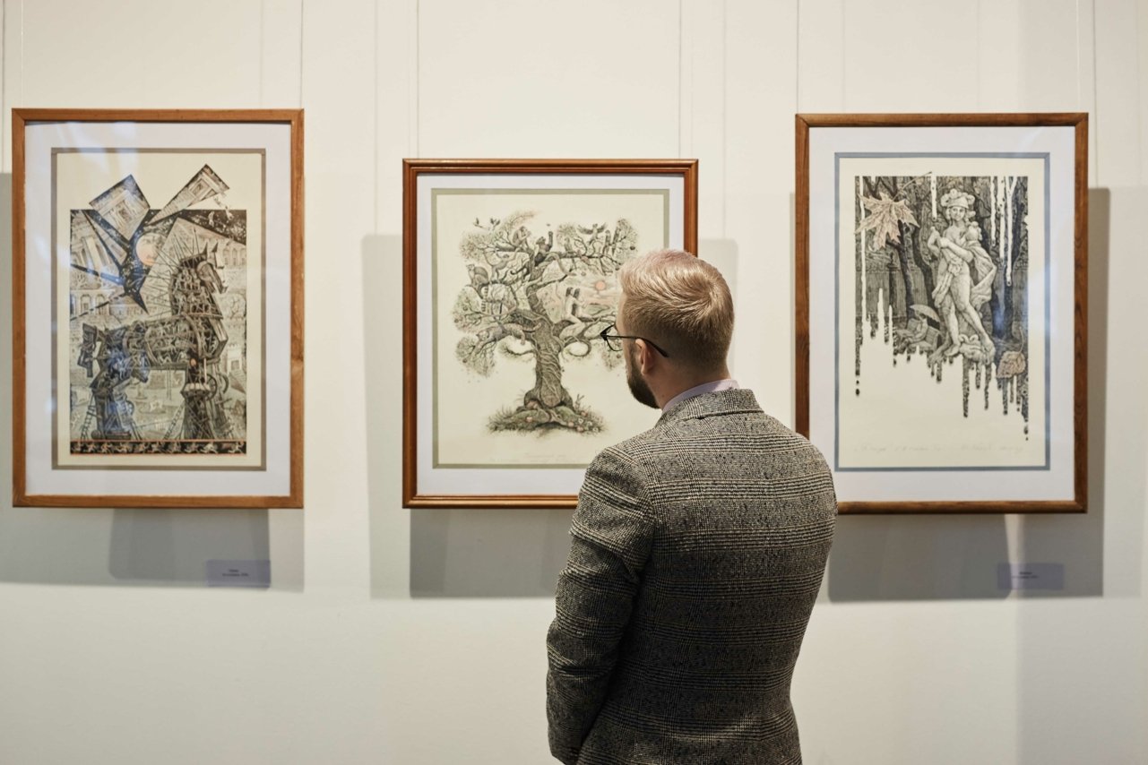A man in a suit looking at framed sketches in an art gallery  Credit   AnnaStills 