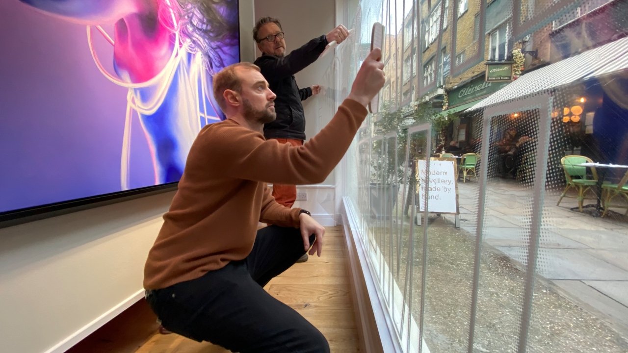 Mike from marketing applying vinyls to the window at St Christopher s Place 